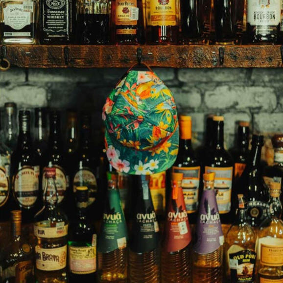photo of liquor and spirits on shelves with colorful hat